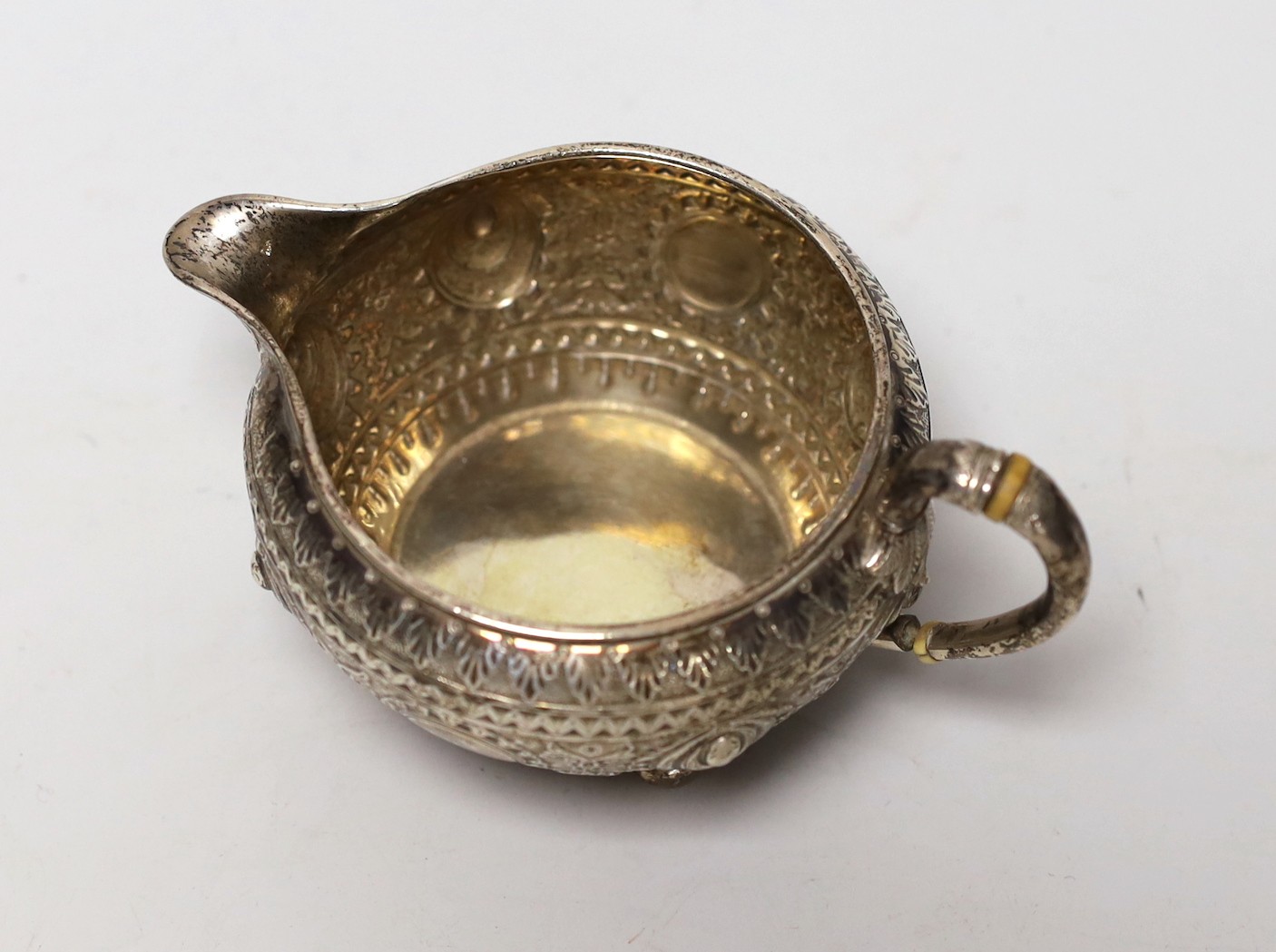 A late Victorian embossed silver cream jug, by Walter & John Barnard, London, 1893, height 74mm, gross weight 5oz.